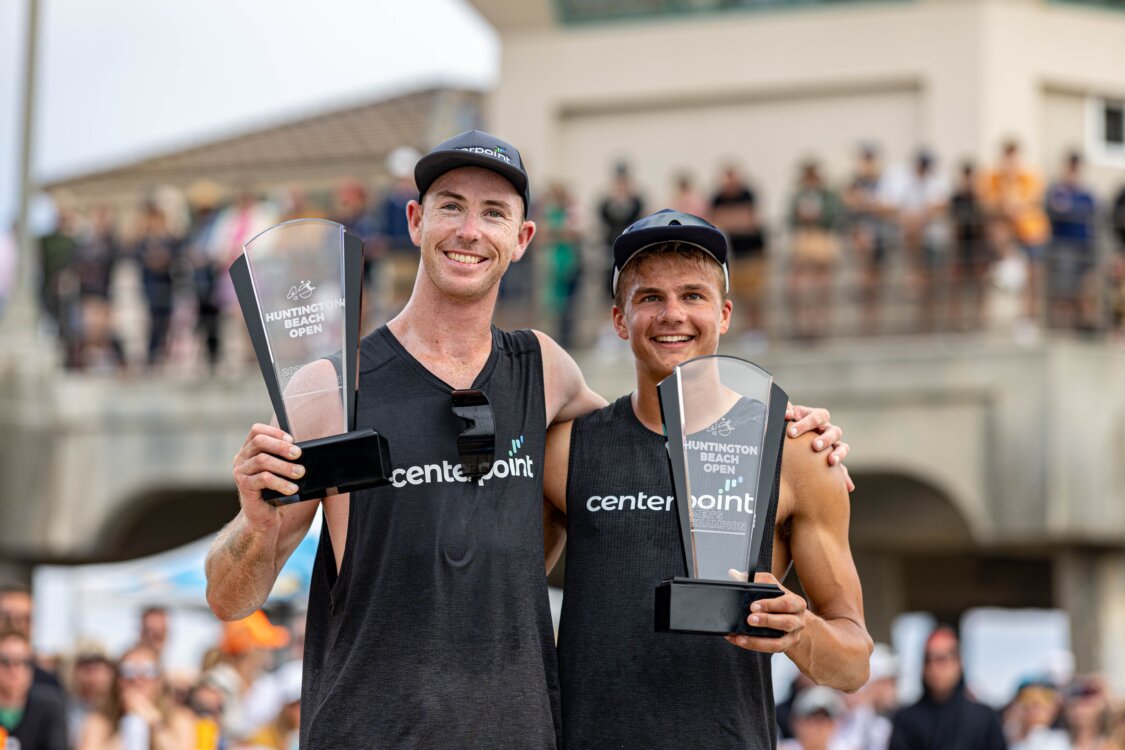 Miles Partain and Andy Benesh hoist their first AVP Pro trophies won as a team at the AVP 2023 Huntington Beach Open. 