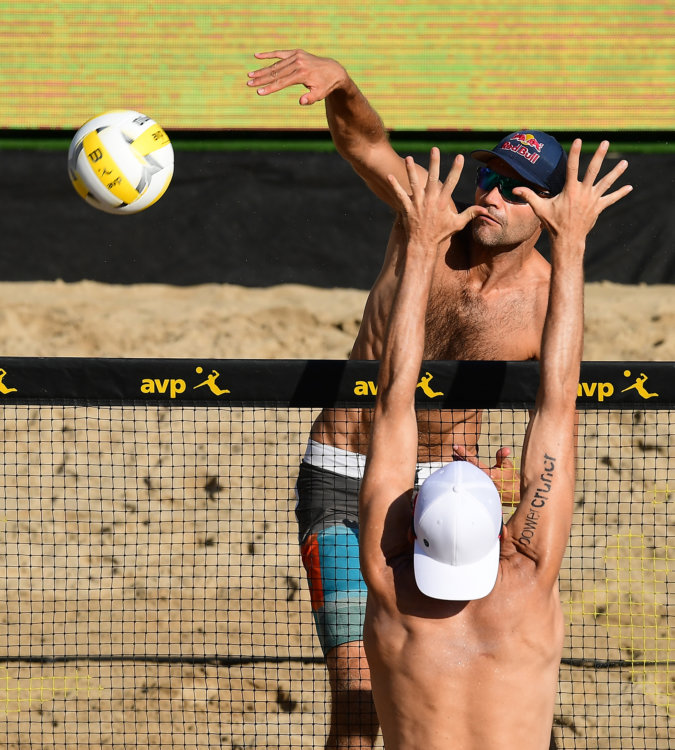 Phil Dalhausser spikes the ball over a defender. 